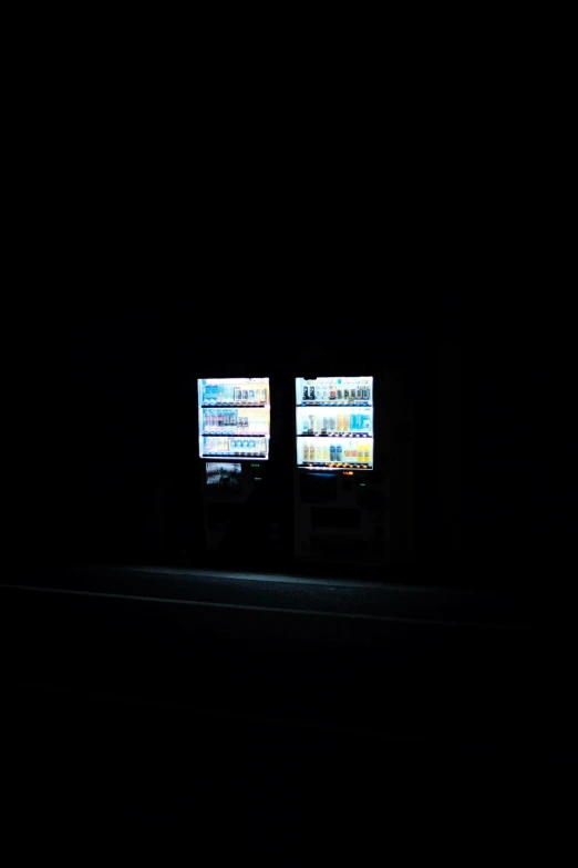 the lights on this black room have two screens displaying television's