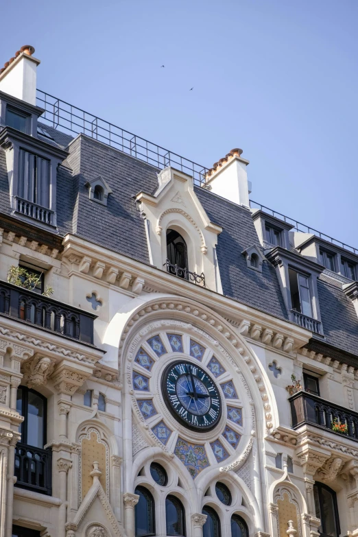 a building with a clock on the front and side of it