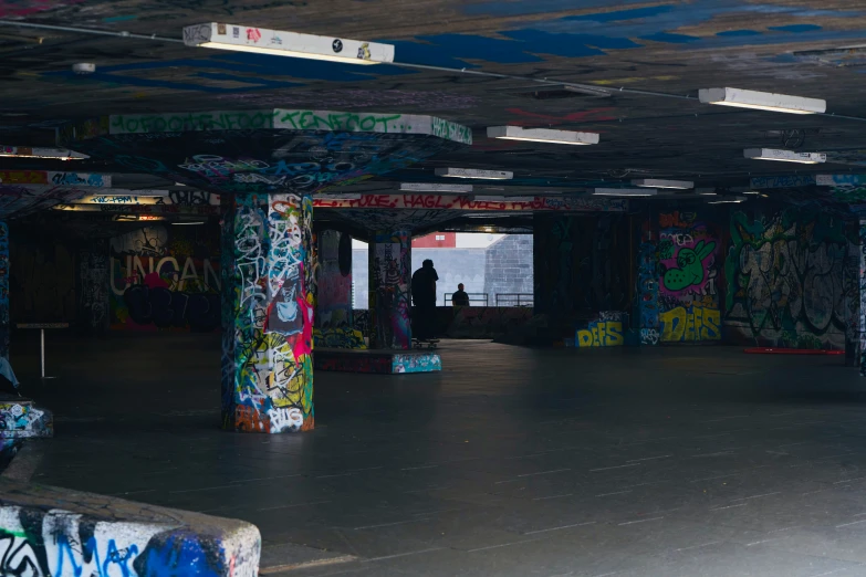 a garage with graffiti on the ceiling and pillars