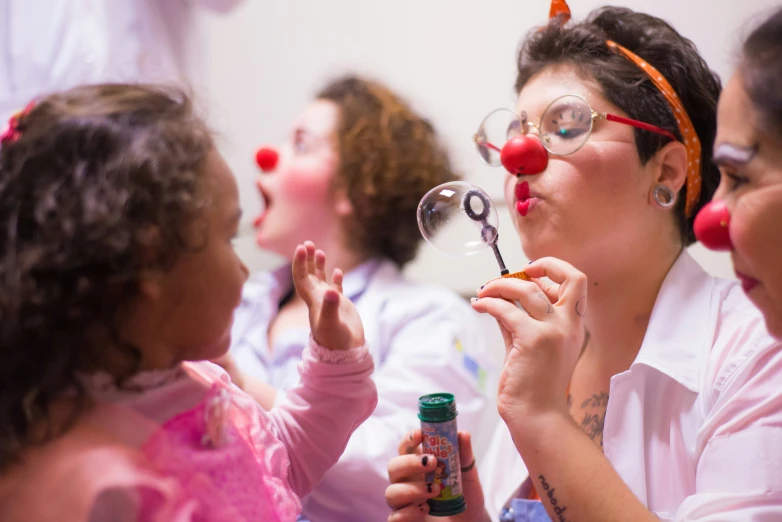 woman blowing bubbles while holding scissors to teeth