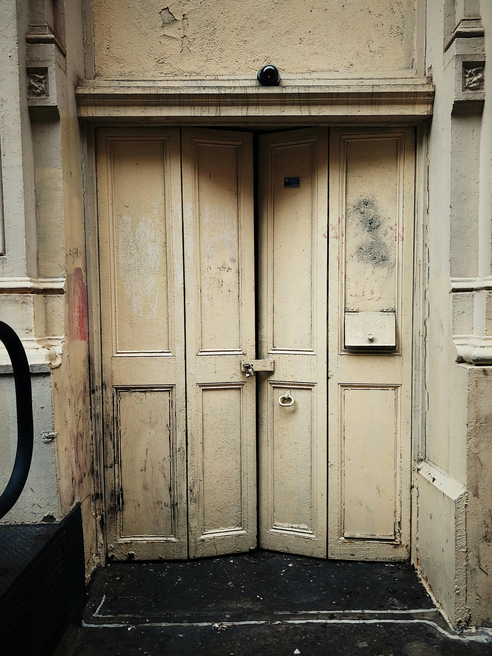 an empty two door entry way on a city street