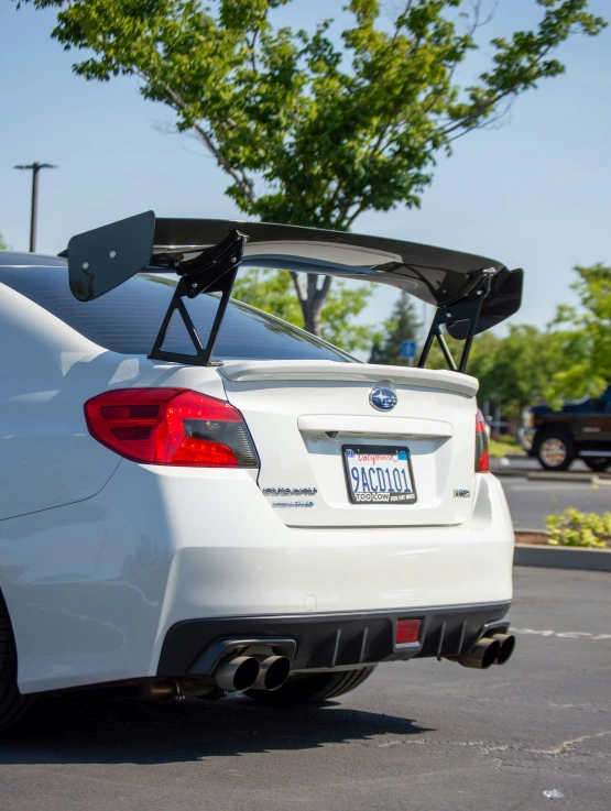 the rear end of a white car with its roof up