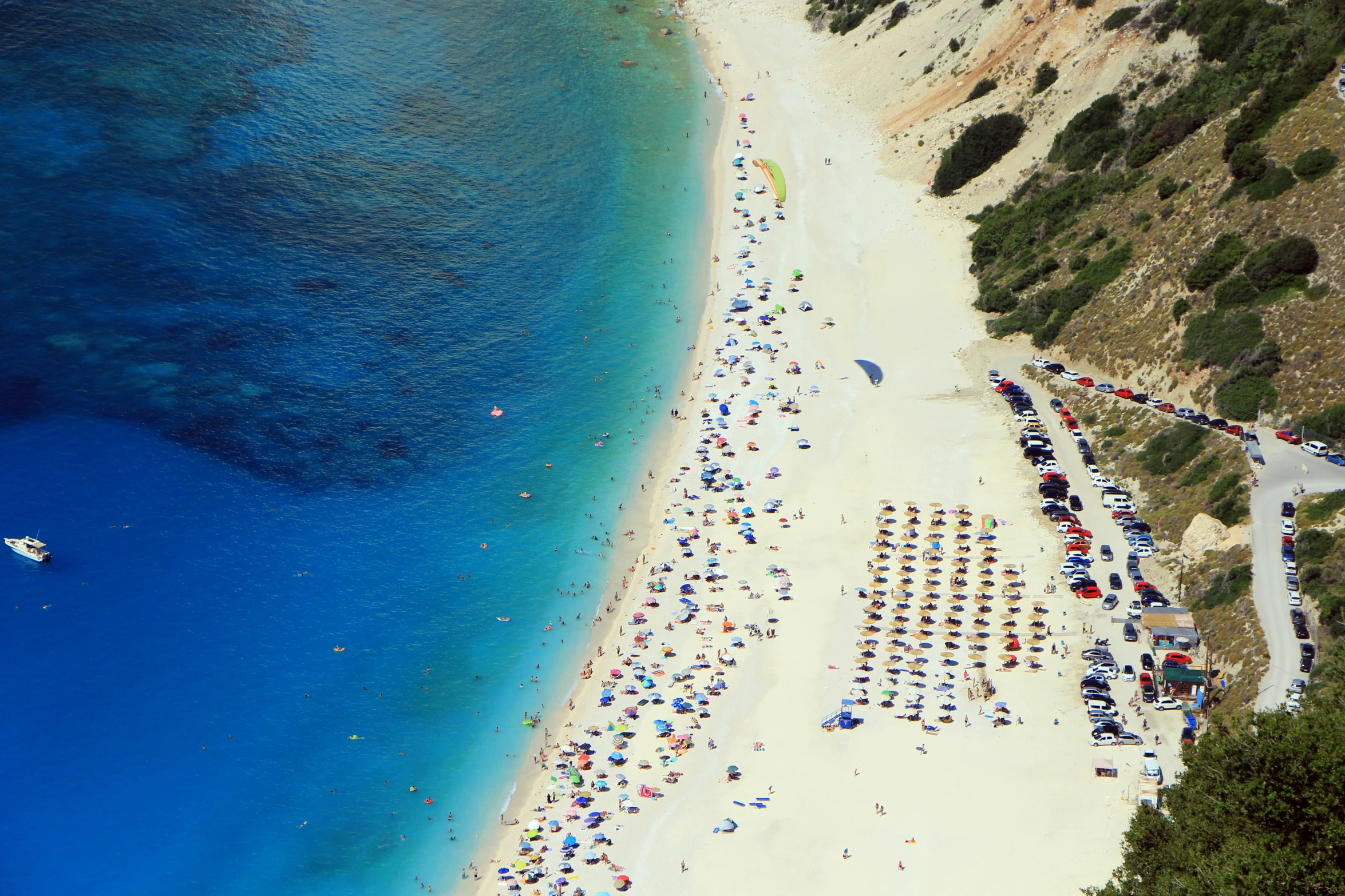 a beach with a white sand and blue water