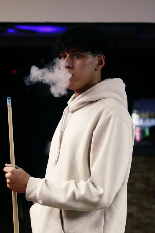 a man smoking a cigarette with a wooden stick