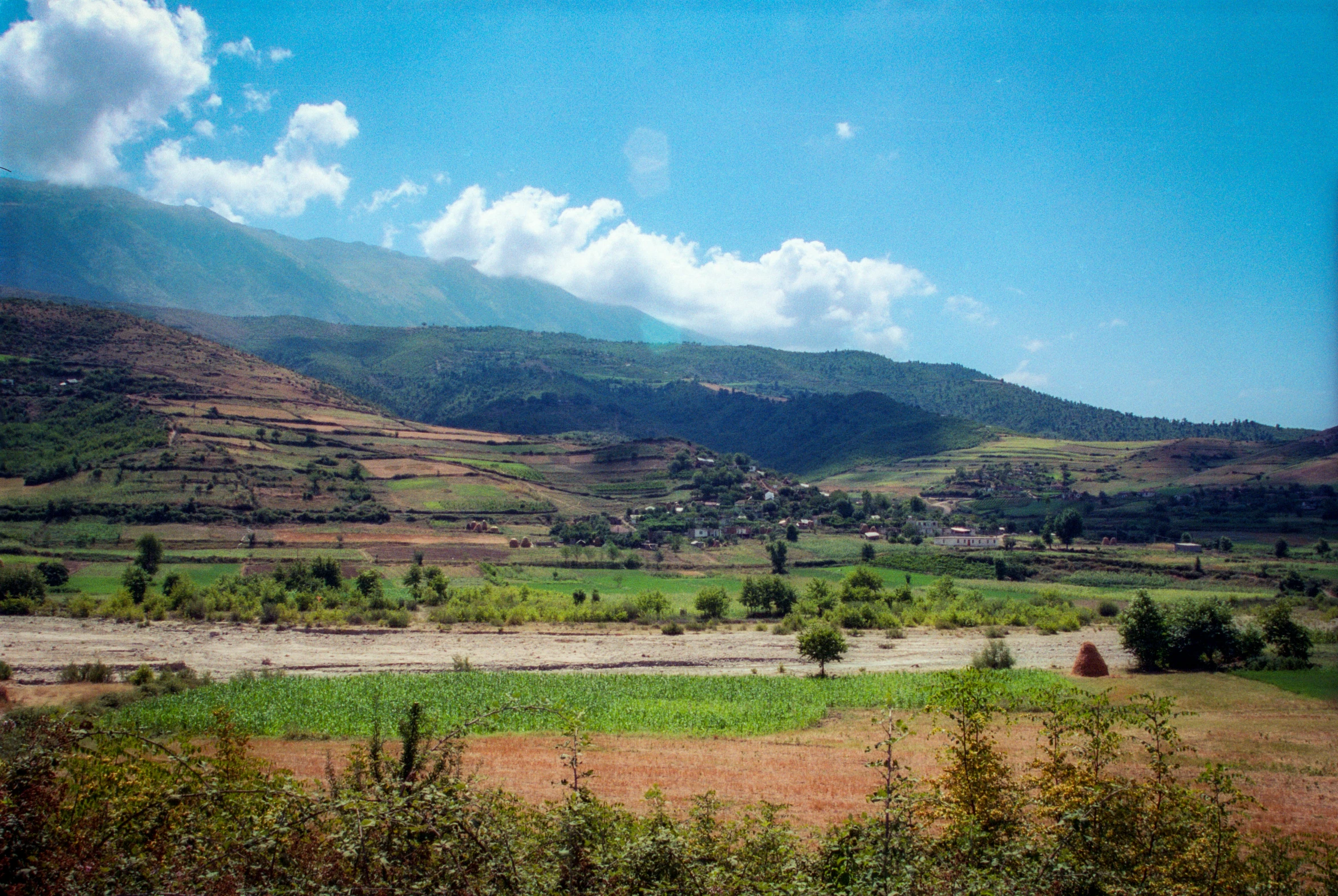 an image of a rural setting as viewed from a hill