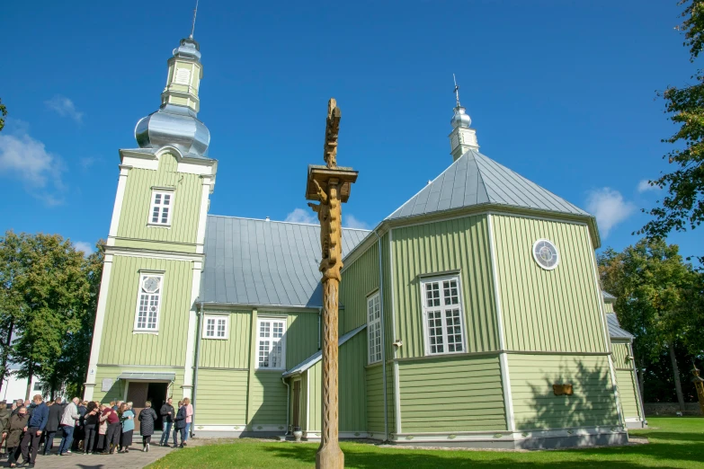 the large building has green and white paint