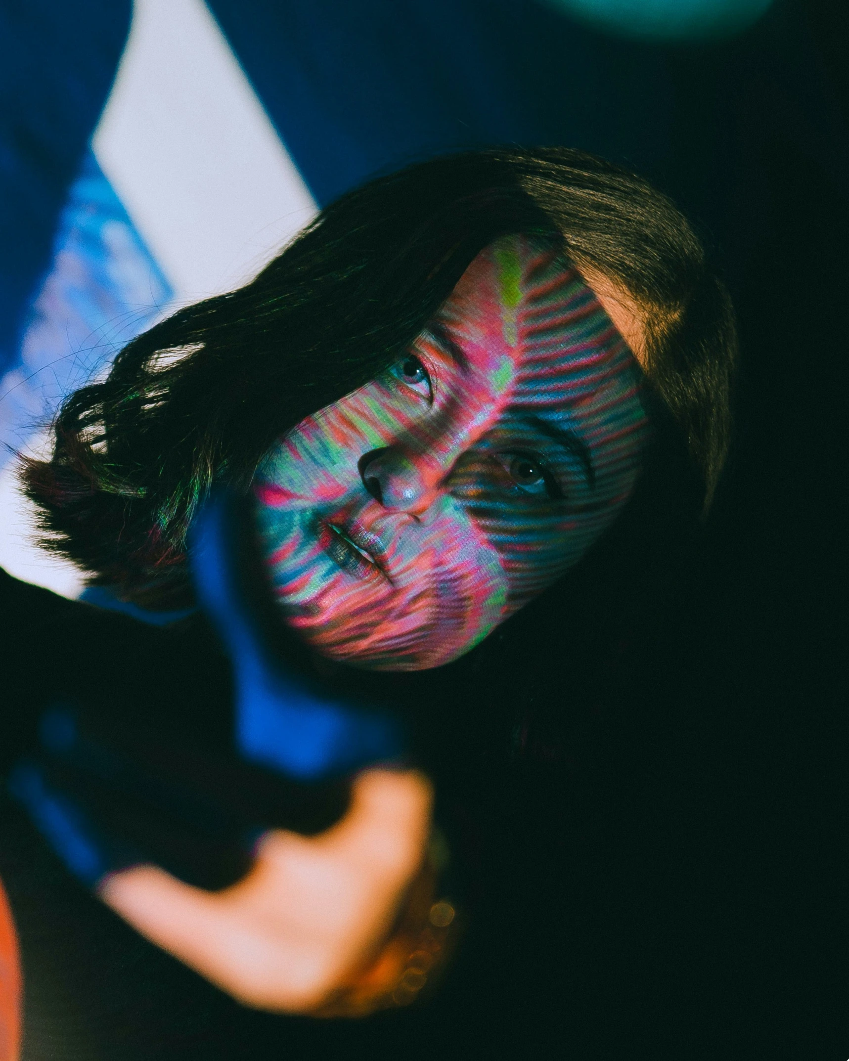 a woman with makeup painted on her face smiling