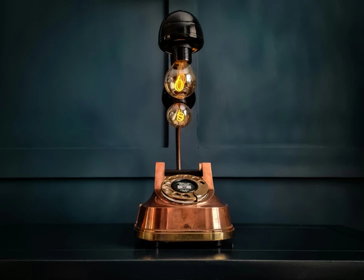 a small antique clock sitting on top of a table