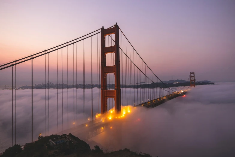 the golden gate bridge over fog in san francisco