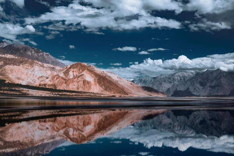 mountain range with a lake surrounded by forest