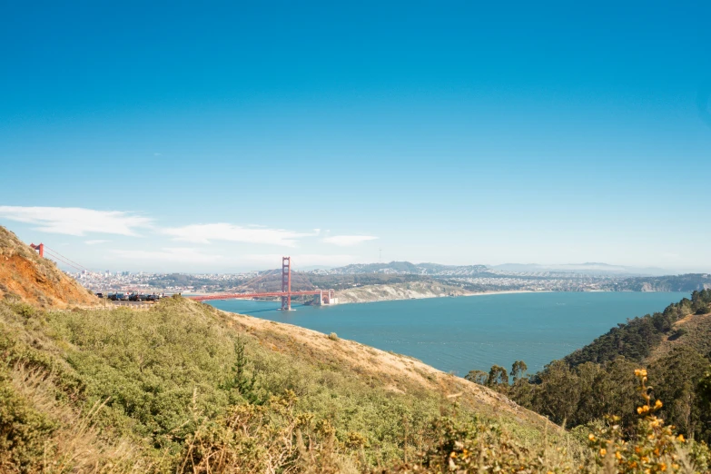 an overlook view of a lake, bridge and a large body of water