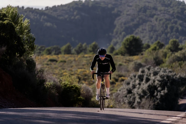 man riding his bicycle down a country road