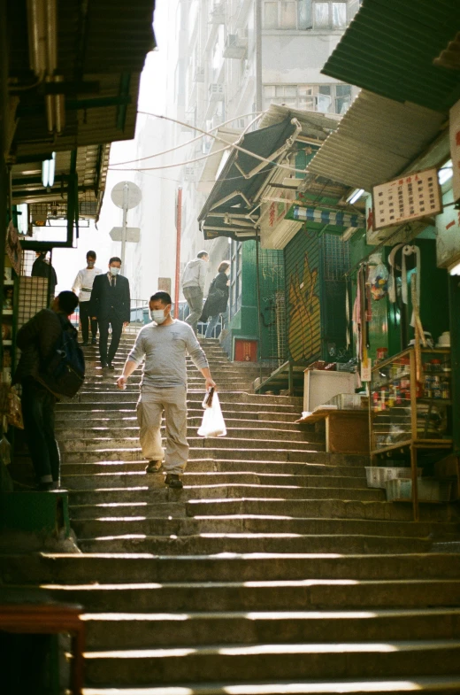 a man walking down some stairs in a market place