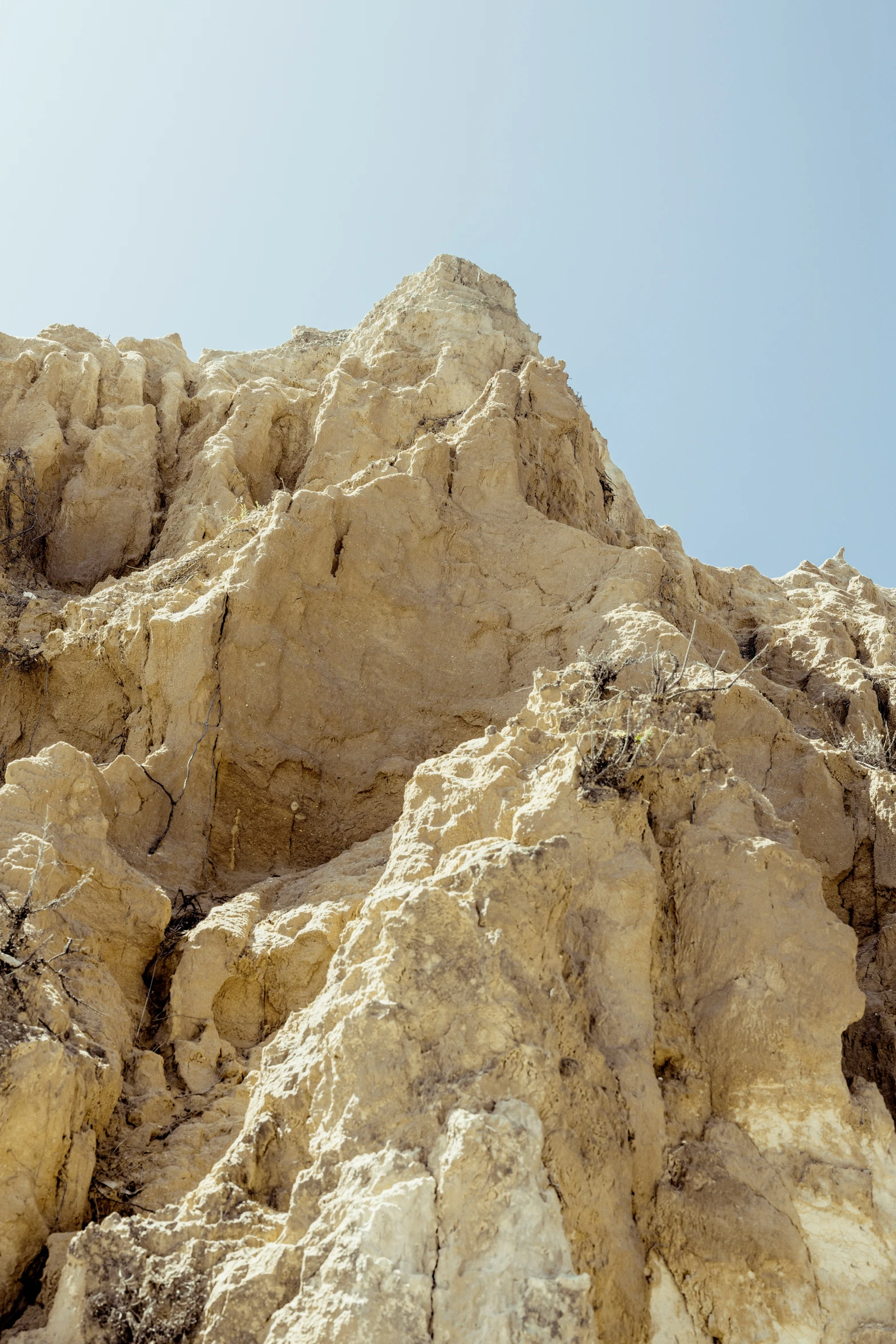 rocks, grass and sand beneath the blue sky