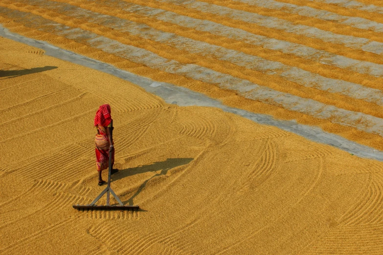 a person walking in the sand behind two people