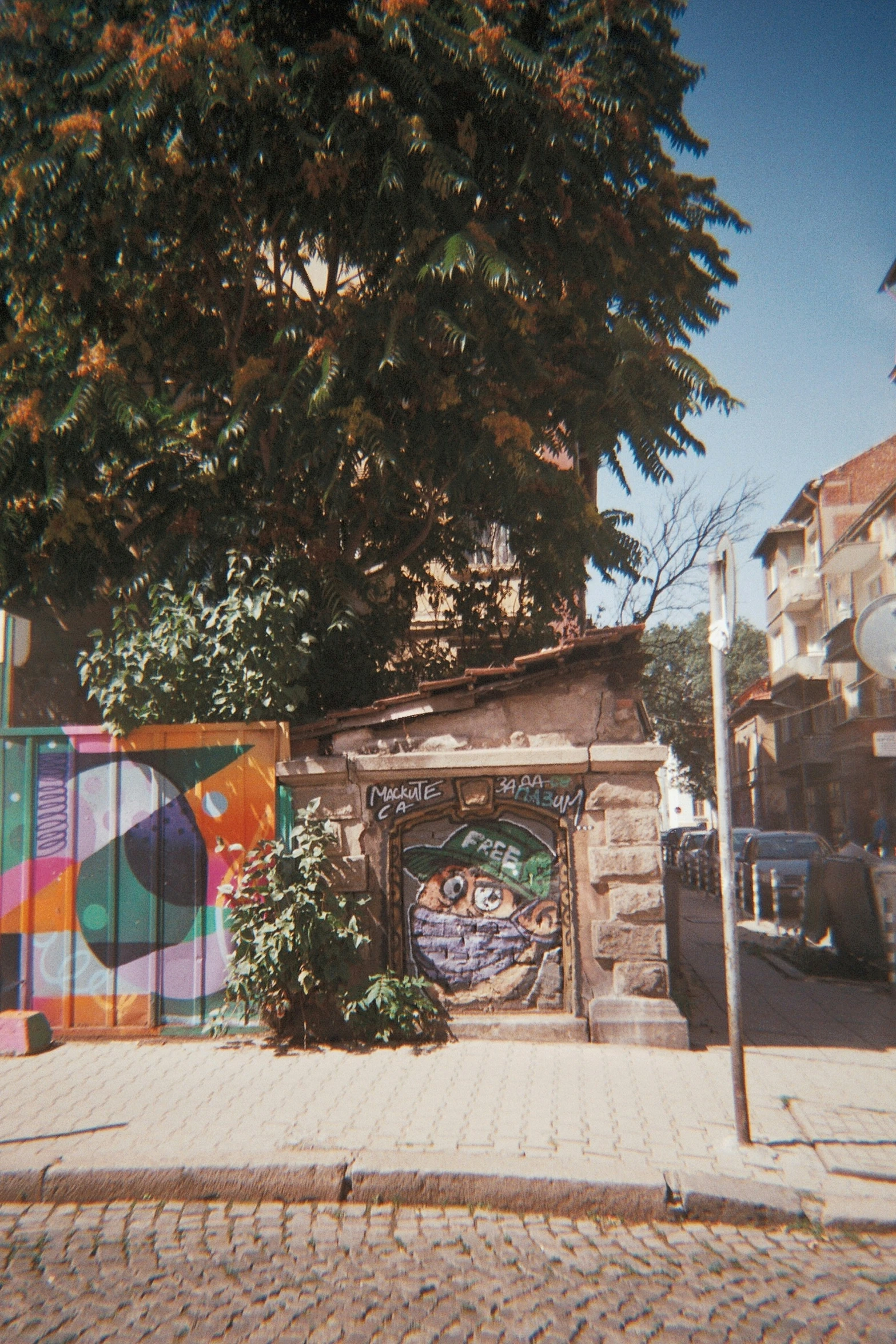 an entrance into a city building with graffiti on it