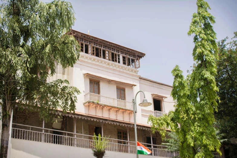 the white building has windows and a balcony