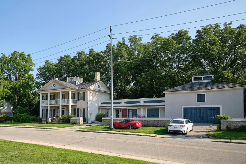 houses and cars are parked along a suburban street