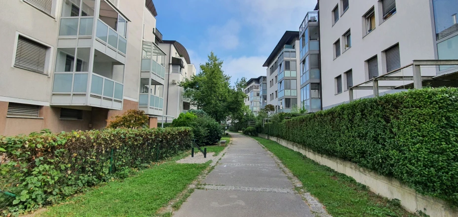 a person walking down a sidewalk near buildings