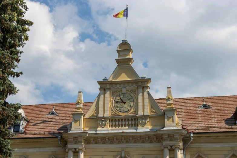 a yellow building with a clock on the front and sides