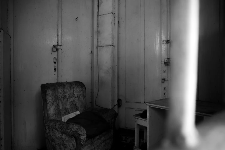 a chair sits in the corner in a dark room