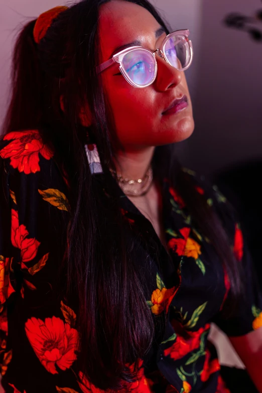 a woman with glasses on her face with red flowers