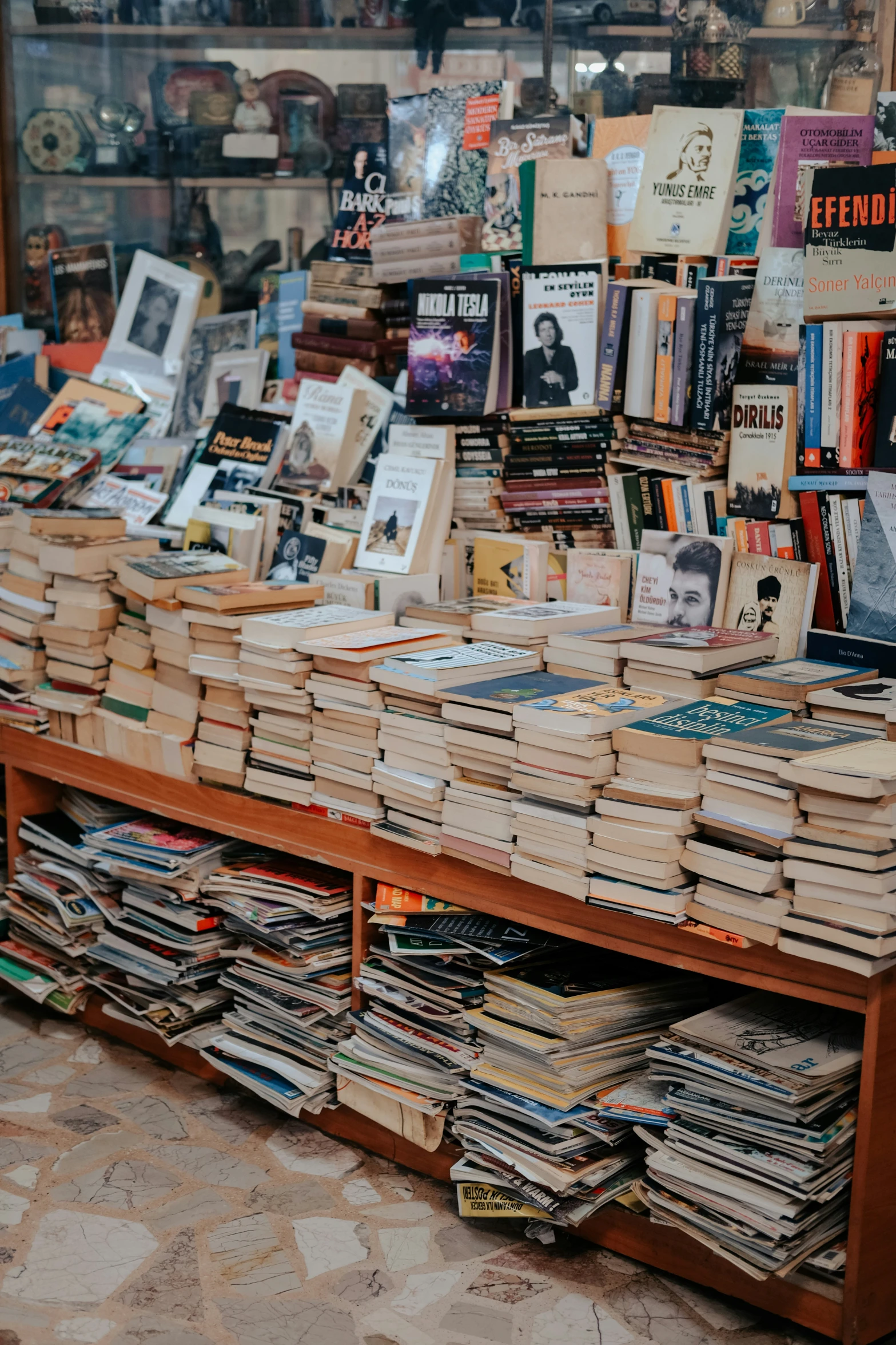 a large amount of books are stacked on a table