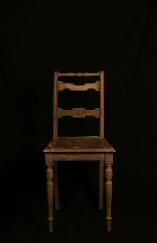 a brown chair with a black back on a dark background