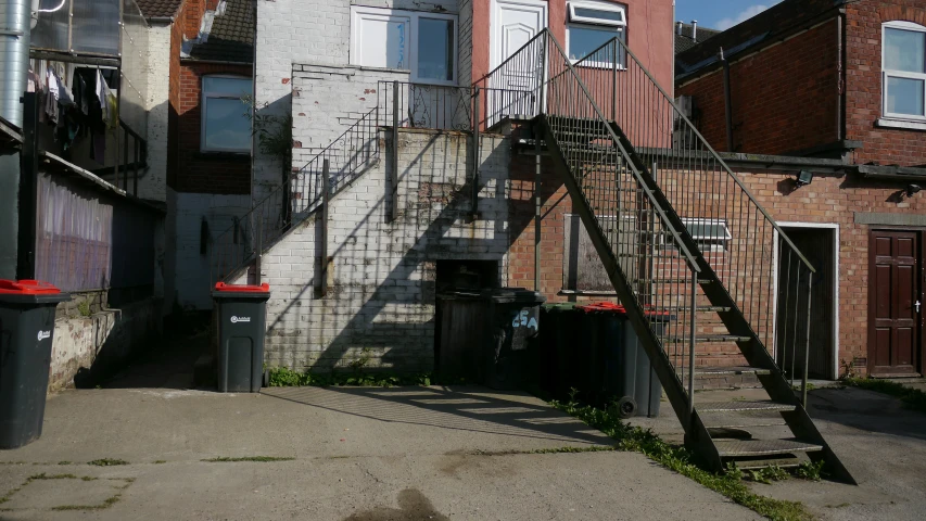 fire escape steps up to a dilapidated house