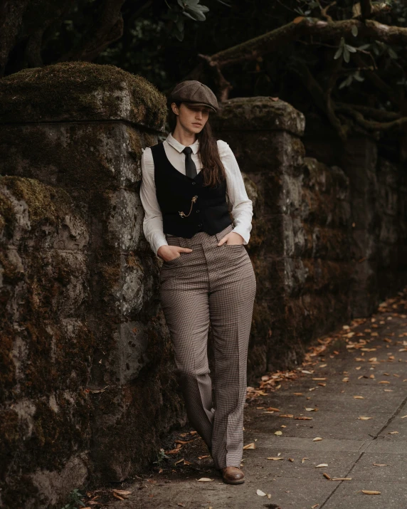 a person is leaning against a rock wall