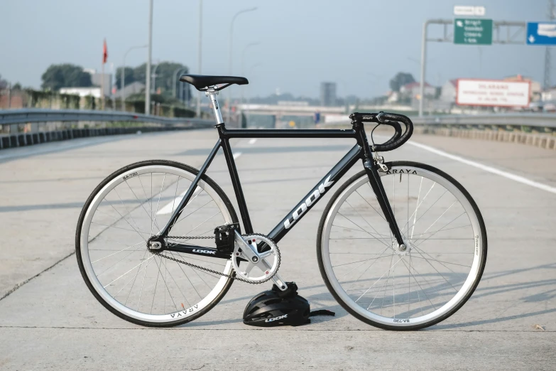 a bike sitting on the ground on a bridge