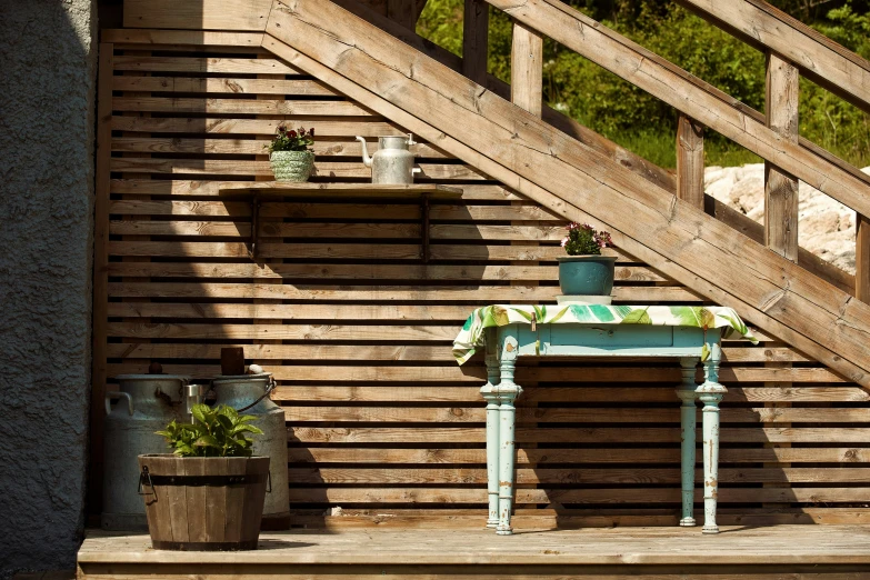 a blue bench sitting in front of a wooden staircase