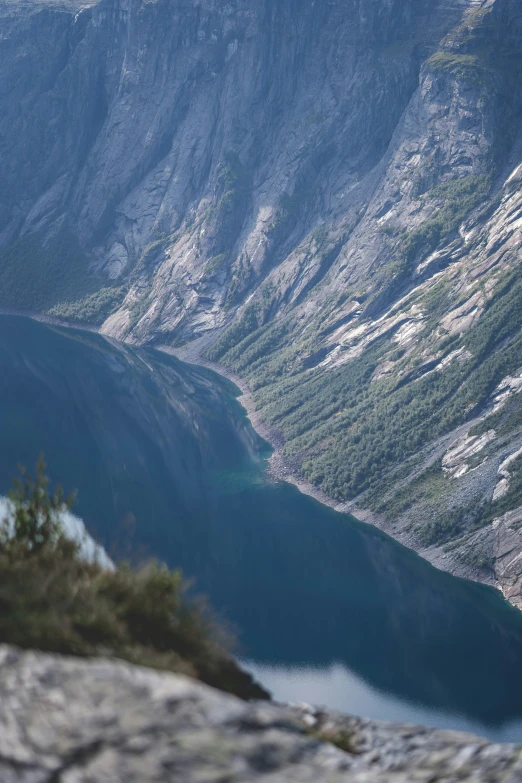 the mountains are on the edge of a body of water