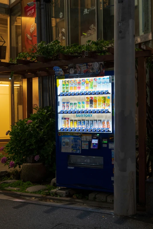 a vending machine is lit up outside a building