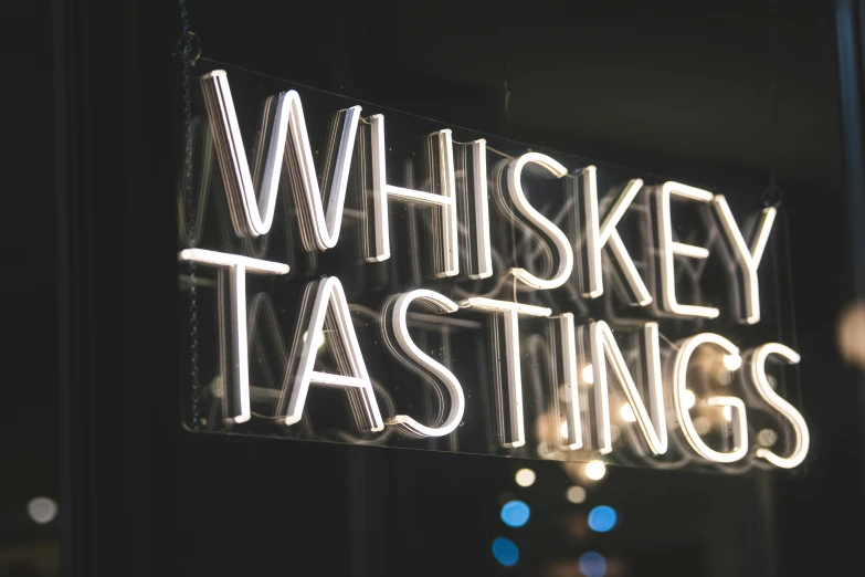 a sign with the words whiskey tasting written in it