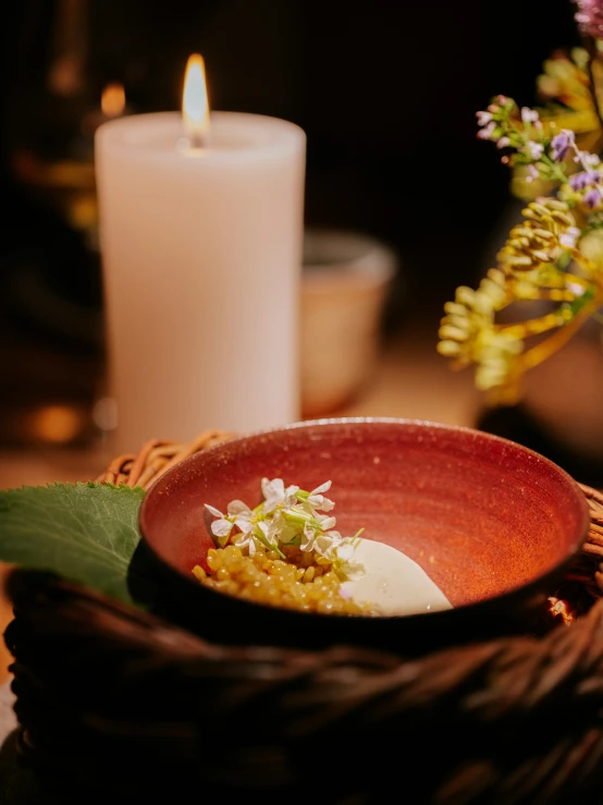 some white candle and bowl on a table