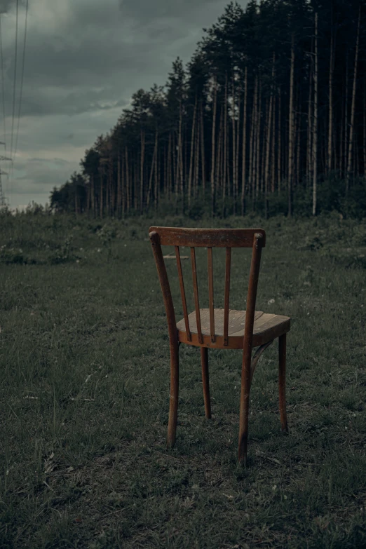 a chair that is sitting in a field