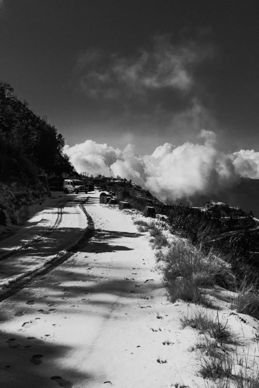 a mountain road with snow on the ground