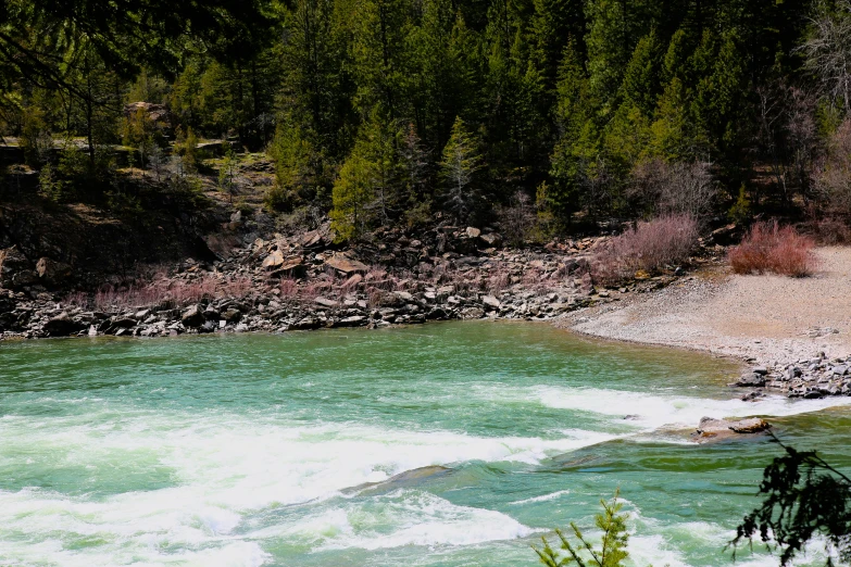 two people in white jackets are walking near water