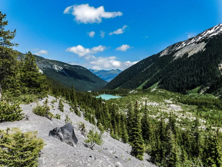 the sky and water are reflecting mountains and trees