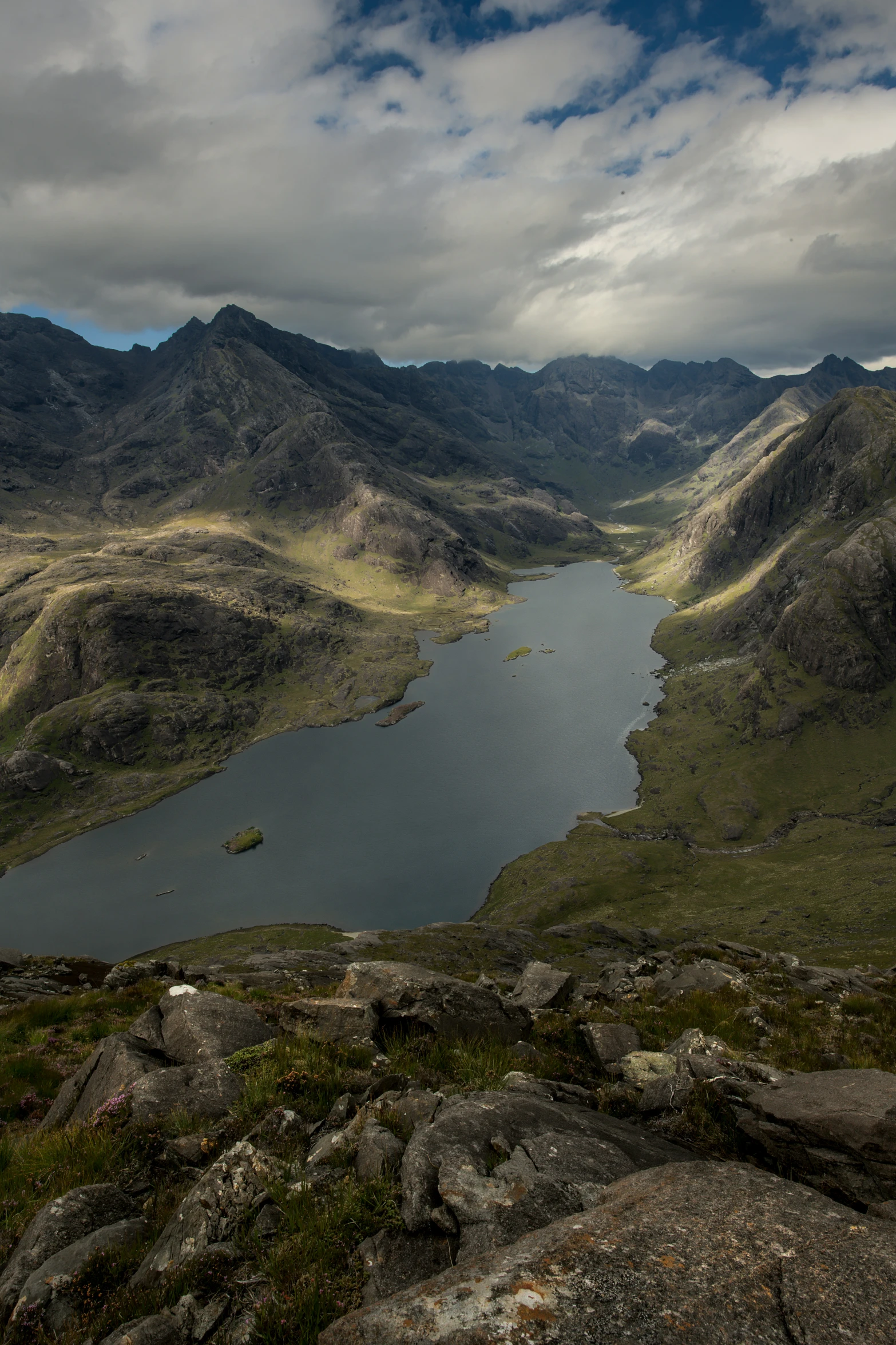 there is a lake surrounded by large rocks