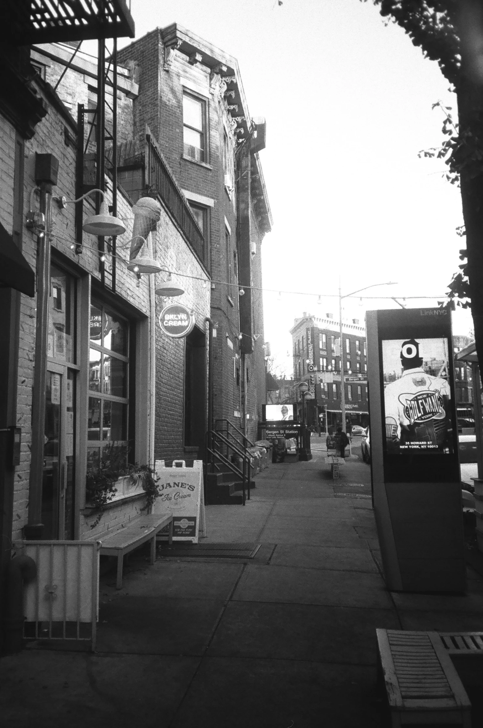 black and white pograph of empty sidewalk during daytime