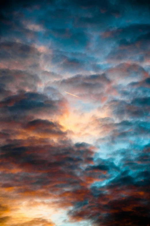 an airplane flying above the clouds in the sunset