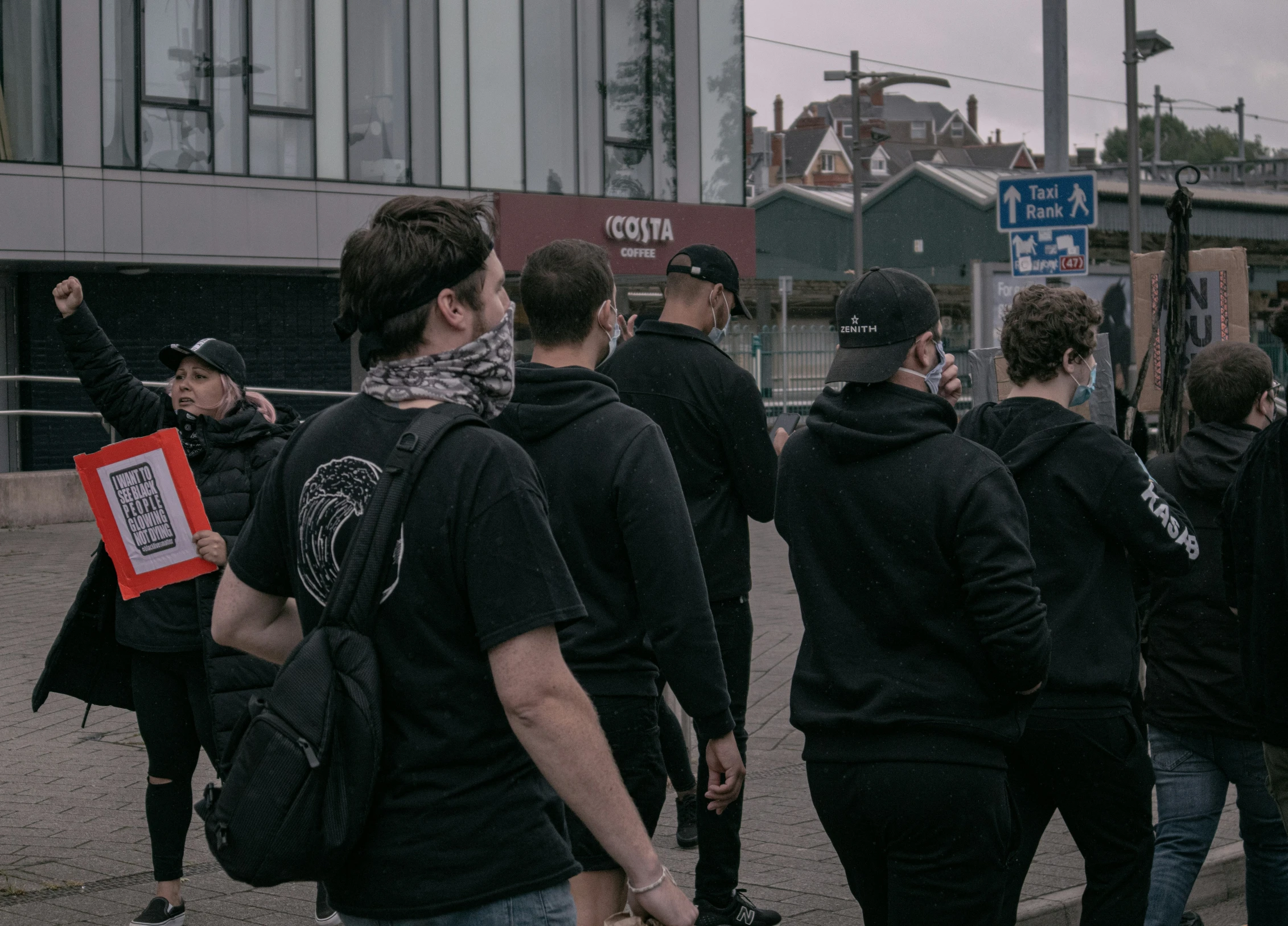 people standing around while dressed up and wearing face masks