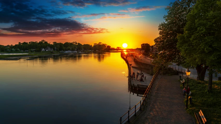 a sunset with many clouds on the water