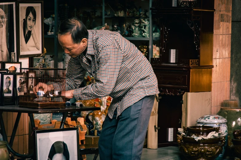 man doing a check - out in the window of a house