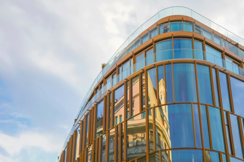 a large glass building on a cloudy day