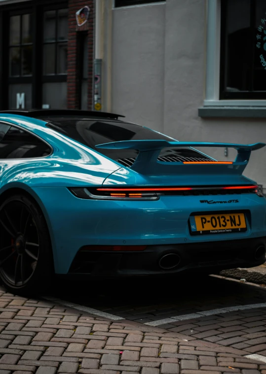 a close up of a light blue sports car