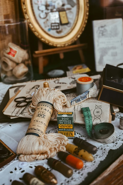 a vintage antique sewing and thread in front of an ornate mirror