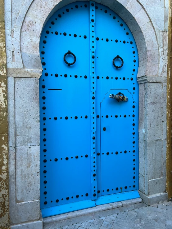 a blue door with black dots on it